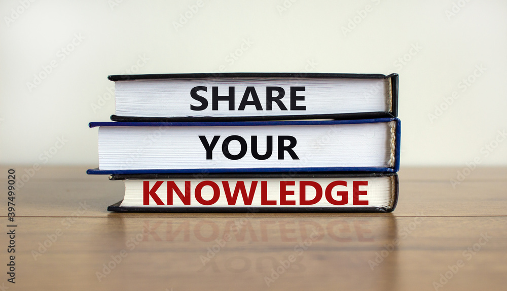 Share your knowledge symbol. Books with words 'share your knowledge' on beautiful wooden table. White background. Business and share your knowledge concept.