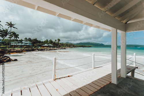 Wide angle view from the inside of the white gazebo on a pier on the paradise beach at Atlantic coast in Las Galeras, Samana, Dominican Republic