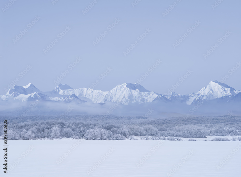 snowbound plain before mountain chain, winter natural concept background