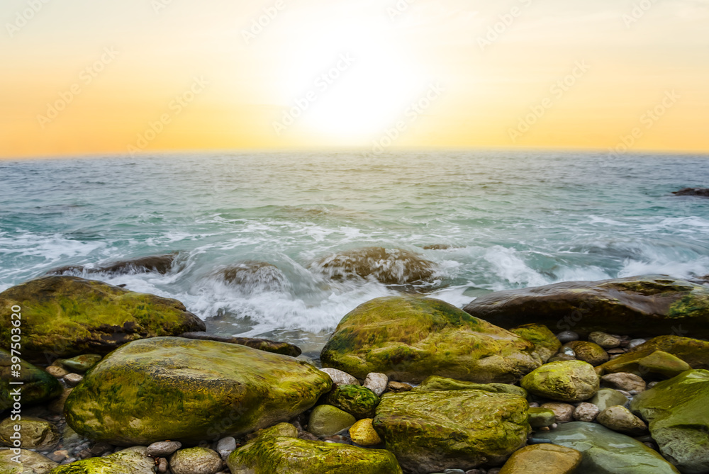sea coast with stones at the sunset, natural sea background