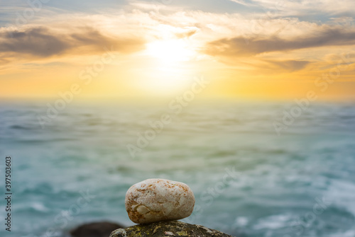 Canvas-taulu small  stone lie on the sea coast at the sunset