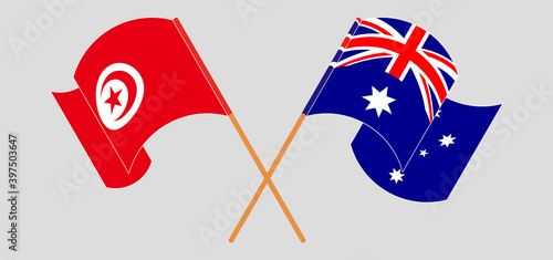 Crossed and waving flags of Tunisia and Australia