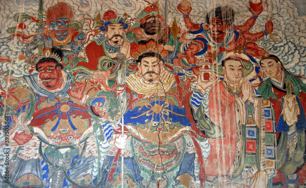 Yungang Grottoes near Datong in Shanxi Province, China. Colorful fresco in a cave at Yungang with characters from history and legend. Yungang Buddhist cave art and sculptures UNESCO world heritage.