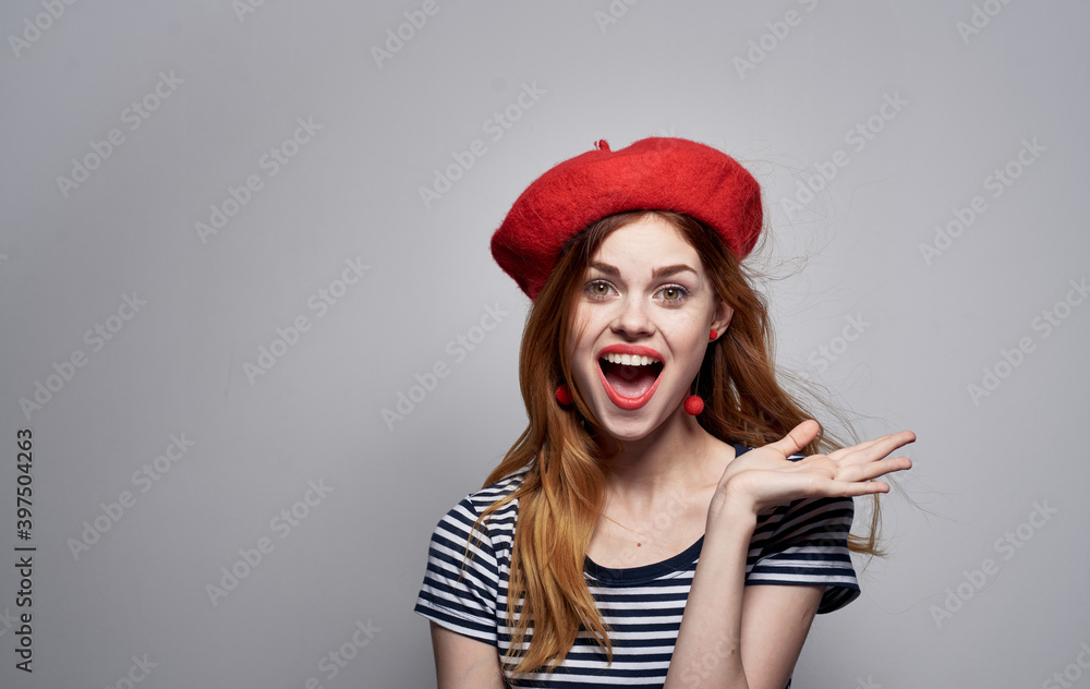 woman in red beret and striped t-shirt cropped view gray background model woman in red beret and striped t-shirt cropped view gray background model