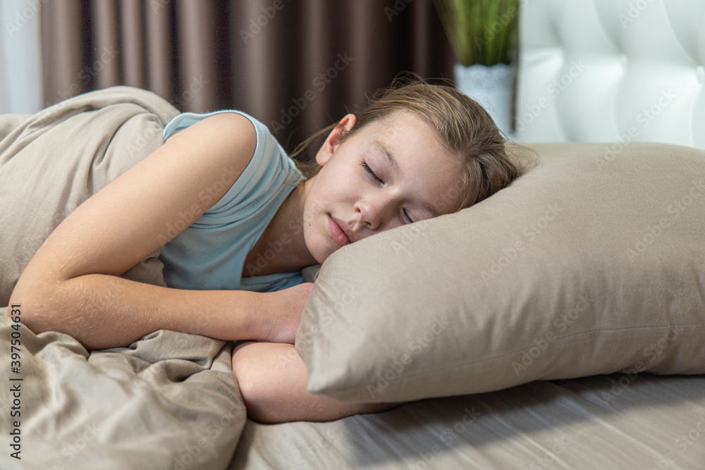 Girl with dark hair sleeps in brown bed Girl with dark hair sleeps in brown bed