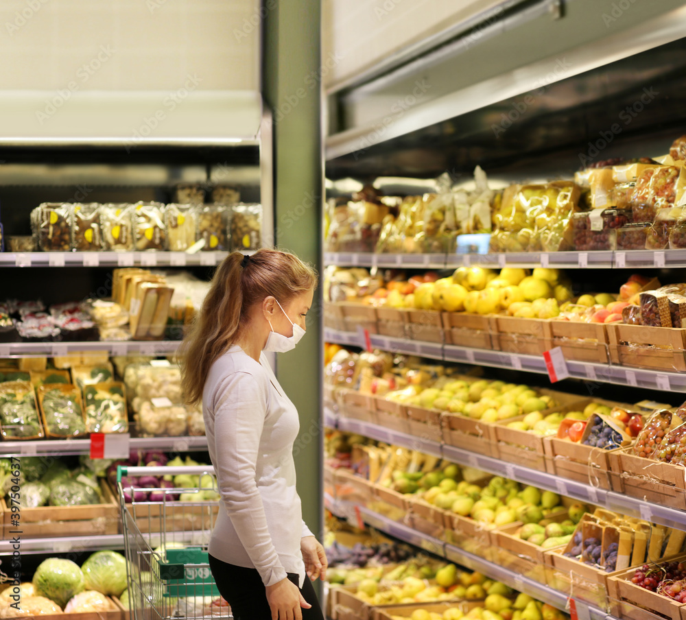 Supermarket shopping, face mask ,woman buying fruits  at the market.