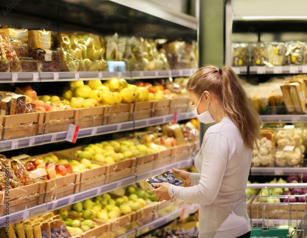 Supermarket shopping, face mask ,woman buying fruits  at the market.