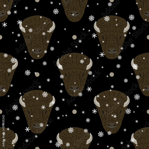 Seamless animal winter pattern with bison heads and snowflakes. Flat cartoon style.