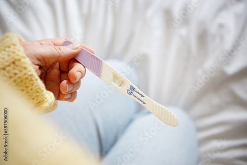 Woman looking on positive pregancy test