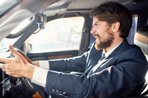 emotional man driving a car gesturing with his hands road track