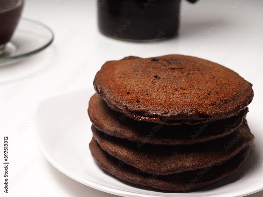 Close up shoot of stacked brown chocolate flafor pancake on an isolated white background Close up shoot of stacked brown chocolate flafor pancake on an isolated white background
