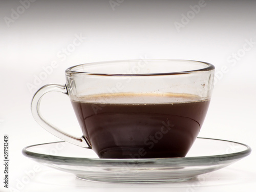 A cup of coffee and french press on a white isolated background
