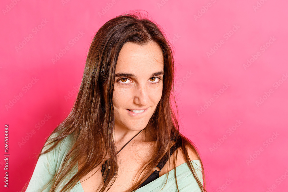 Young woman looks to the face sweetly and mischievously looking to flirt, isolated on background Young woman looks to the face sweetly and mischievously looking to flirt, isolated on background
