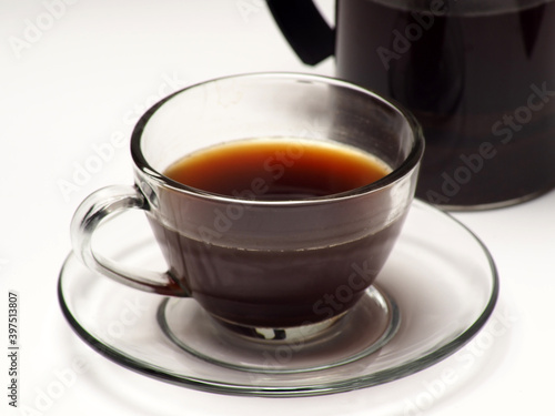 A cup of coffee and french press on a white isolated background