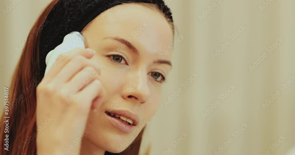 Facial skin care. Woman doing a facial massage Facial skin care. Woman doing a facial massage