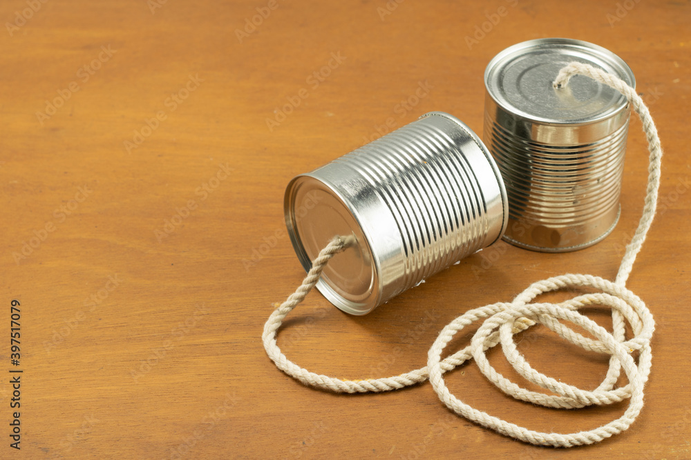 Cans joined by cord as a telephone Cans joined by cord as a telephone