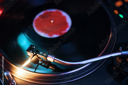 dj vinyl record in a nightclub with beautiful colors and reflections