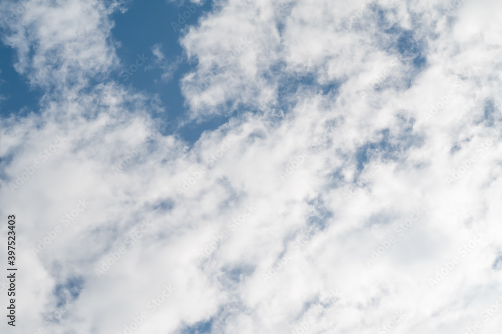 Obraz premium Altocumulus clouds against blue sky background.