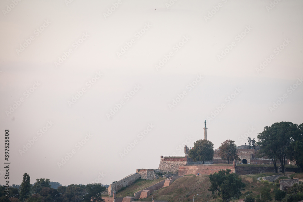 View of Kalemegdan fortress seen from the sava river bank with a focus on the Viktor pobednik statue in front, one of the major landmarks of Belgrade, Serbia