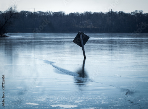 Sign On Icy Water with reflection