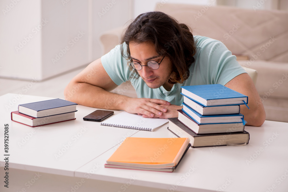 Young male student preparing for exams at home Young male student preparing for exams at home