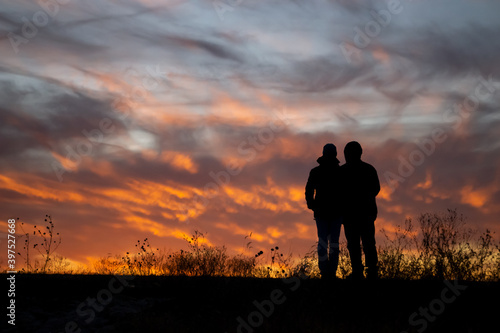 Silhouette of couple in front of sunset