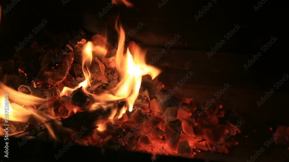 View on fireplace with burning wood and coals