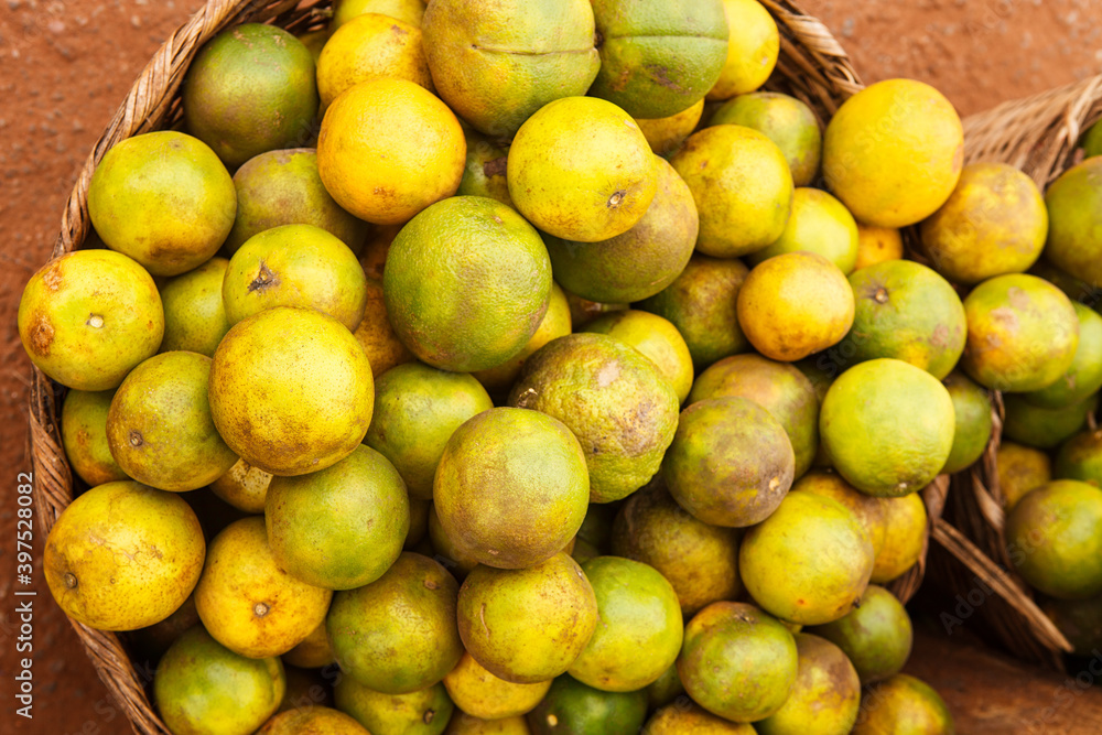 Basket overflowing with oranges in Ghana West Africa