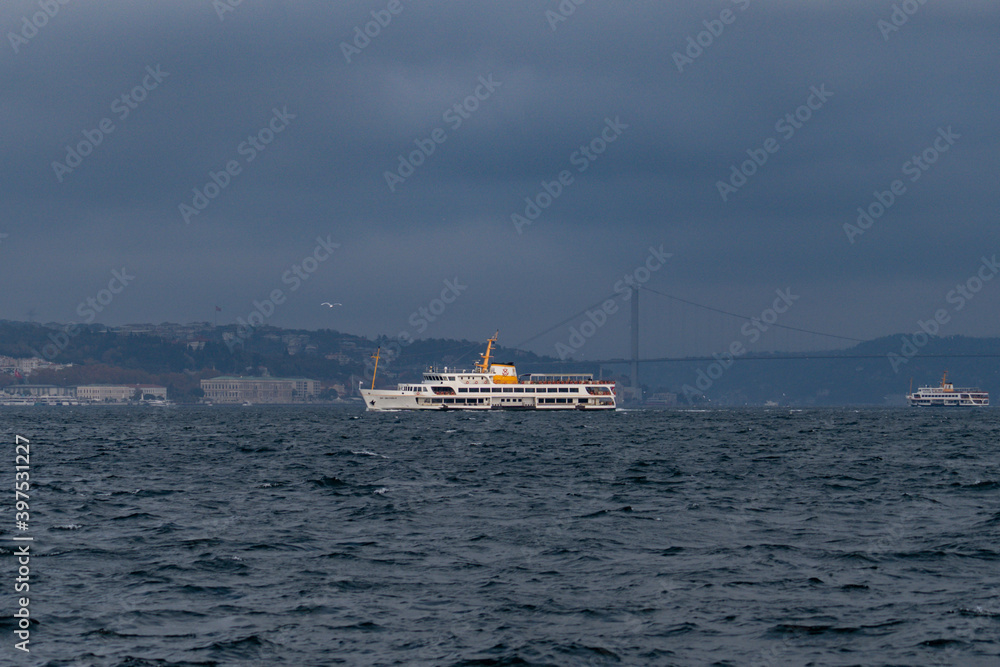 Boat and a ferry at the Bosporus on a cloudy day but clear weather