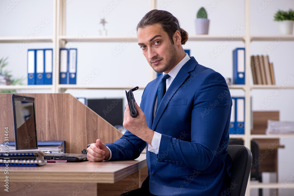 Young male bookkeeper working in the office
