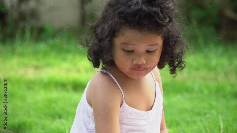 Curly haired asian Happy girl sitting making make up with mother cosmetics. Learning to be a woman Curly haired asian Happy girl sitting making make up with mother cosmetics. Learning to be a woman