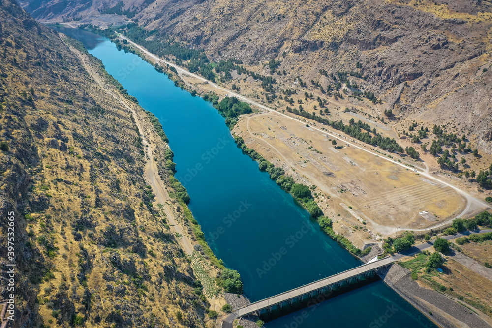 A river from the lake of Ataturk Dam at Anatolia.Biggest river in Turkey for agricultural using.The drone shots of the river on a sunny day.
