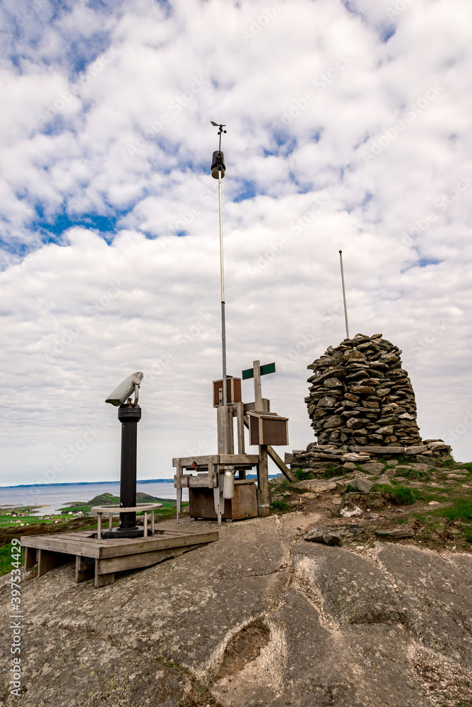 Observation viewpoint with binoculars, visitors box and a pile of stones at Mastravarden hill top at Mosteroy island, Rennesoy commune, Stavanger, Norway, May 2018