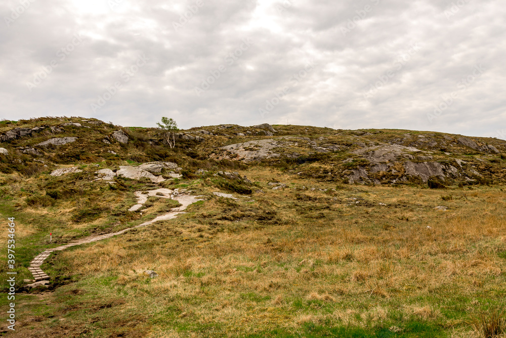 Hiking track leading to top of Mastravarden hill on Mosteroy island, Rennesoy kommune, Stavanger, Norway, May 2018