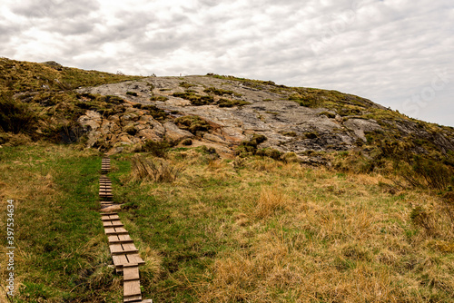 Obraz na płótnie Wooden boardwalk steps on a hiking track leading to top of Mastravarden hill on Mosteroy island, Rennesoy kommune, Stavanger, Norway, May 2018 w salonie