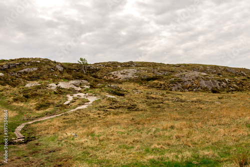 Obraz na płótnie Hiking track leading to top of Mastravarden hill on Mosteroy island, Rennesoy kommune, Stavanger, Norway, May 2018 w salonie
