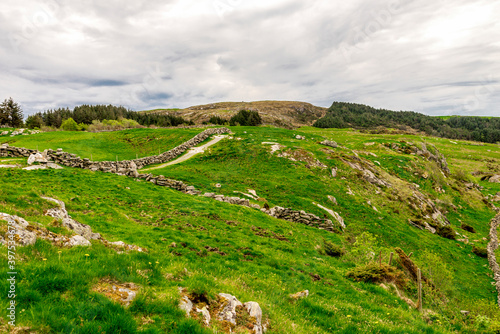 Obraz na płótnie Green slopes of Mosteroy island with Mastravarden hill in a distance, Rennesoy kommune, Stavanger, Norway, May 2018 w salonie