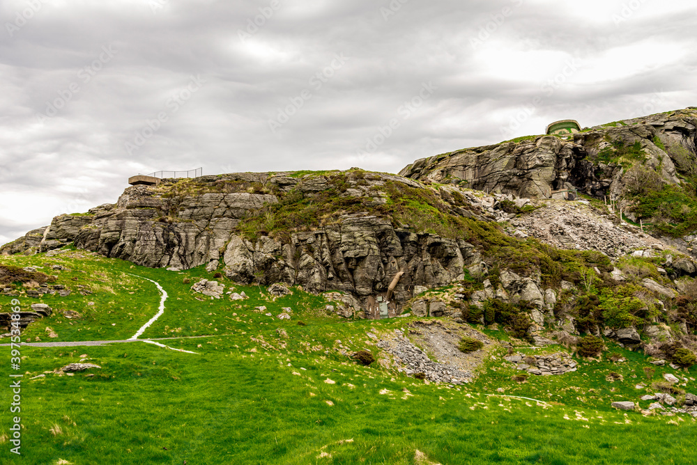A footpath going uphill to the sentry watchhouse at Fjoloy fort historical site, Rennesoy kommune, Stavanger, Norway, May 2018
