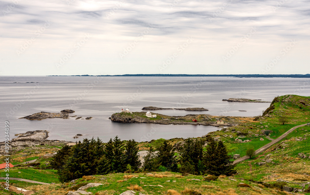 Scenic landscape view of small islands and historical Fjoloy lighthouse from top of the hill, Rennesoy kommune, Stavanger, Norway, May 2018