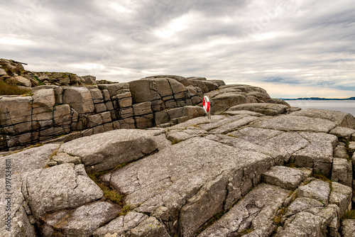 Obraz na płótnie A lifebuoy set at rocky coastline along Fjoloy fort historical site, Rennesoy kommune, Stavanger, Norway, May 2018 w salonie