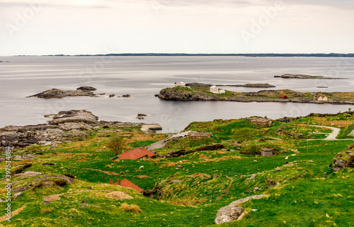 Obraz na płótnie A panoramic scenic view to Fjoloy fort site and lighthouse from the top of the hill, Rennesoy kommune, Stavanger, Norway, May 2018 w salonie