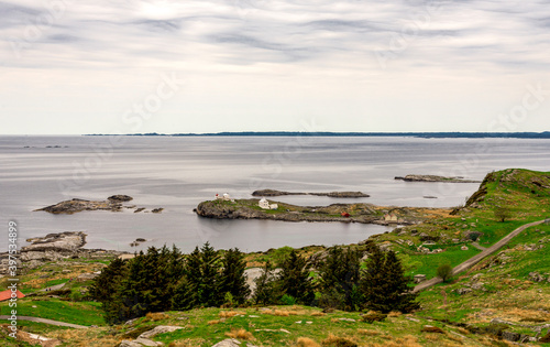 Obraz na płótnie Scenic landscape view of small islands and historical Fjoloy lighthouse from top of the hill, Rennesoy kommune, Stavanger, Norway, May 2018 w salonie