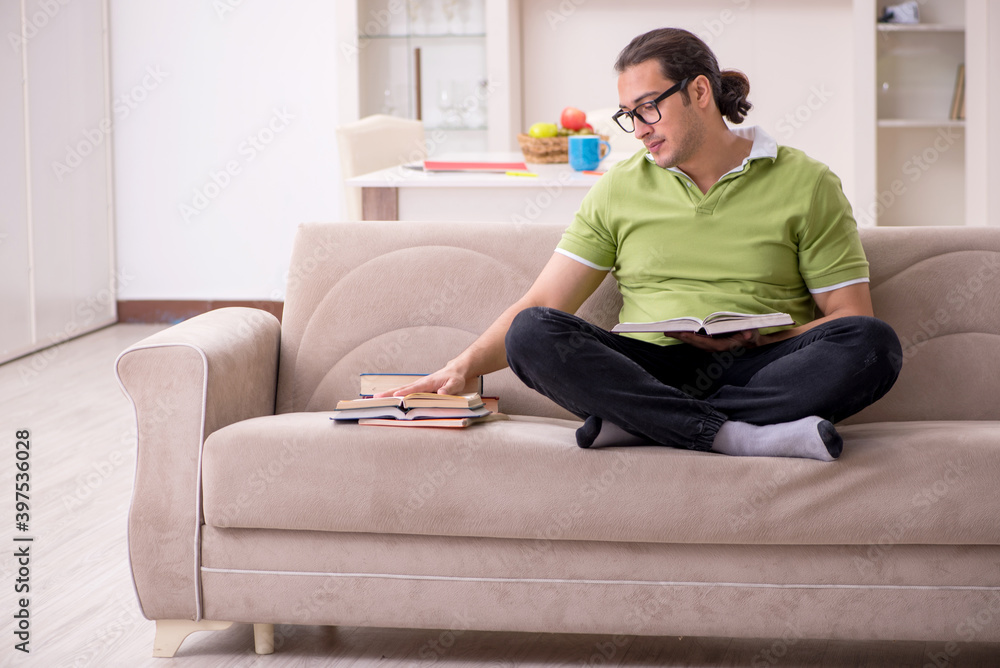 Young male student preparing for exams at home Young male student preparing for exams at home