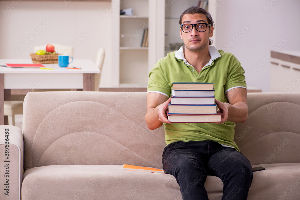 Young male student preparing for exams at home Young male student preparing for exams at home