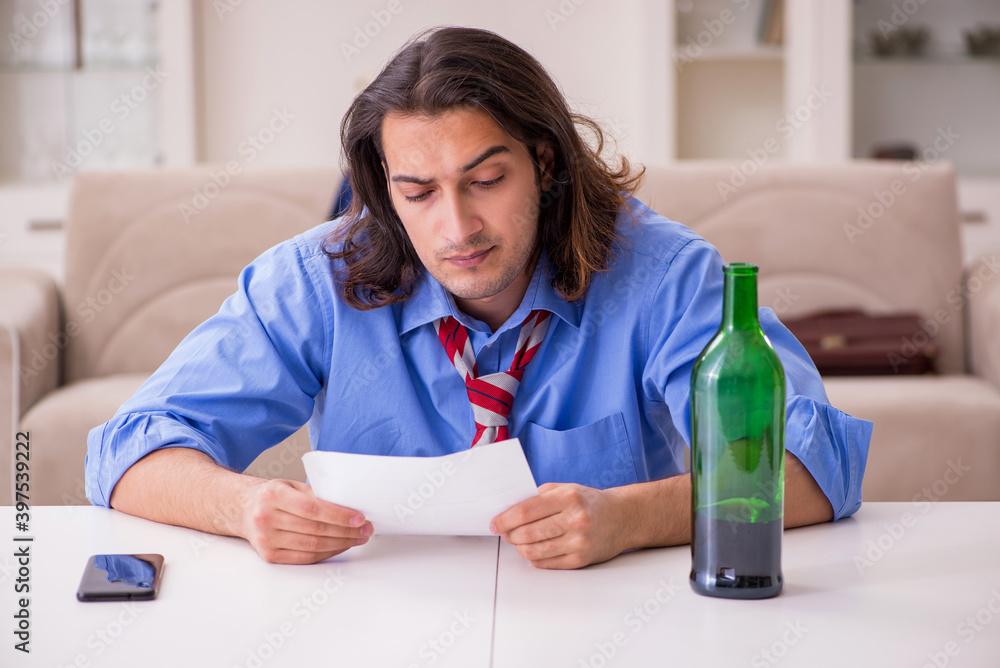 Young male employee being fired from his work at home Young male employee being fired from his work at home