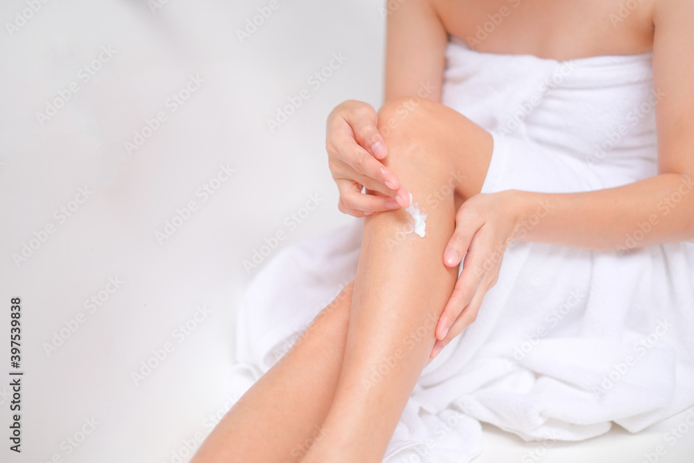 Woman applying cream,lotion on leg with white background, Beauty concept. Woman applying cream,lotion on leg with white background, Beauty concept.