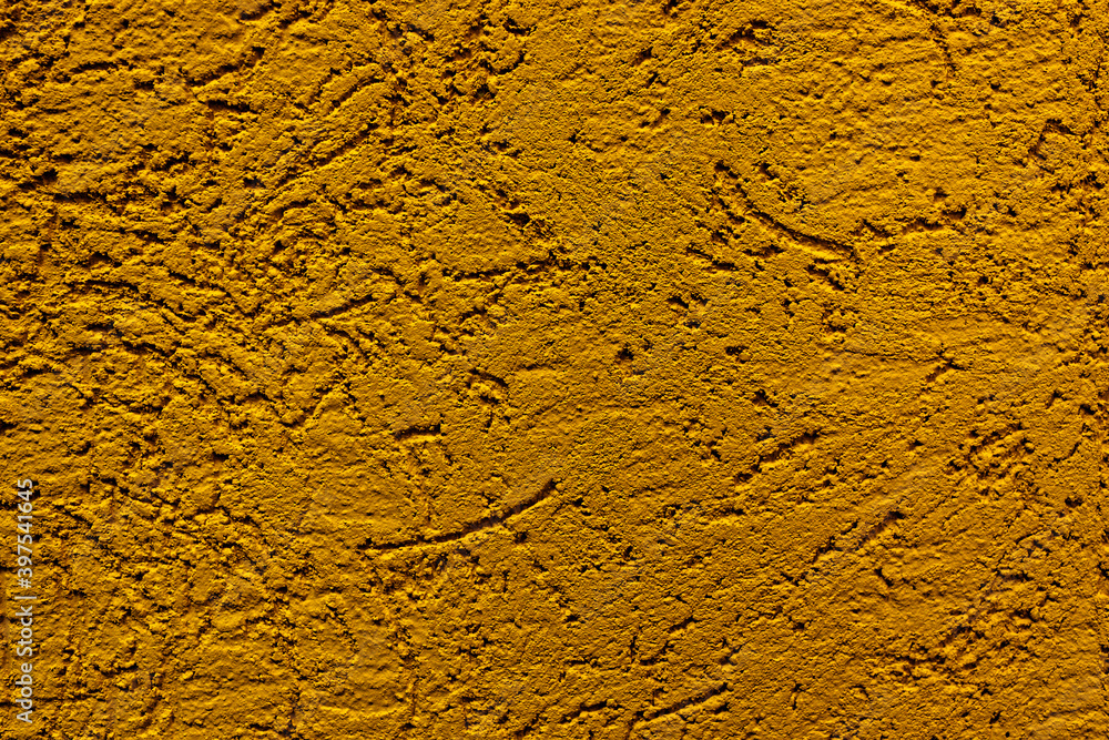 The wall is made of plaster with scratches. Rough surface. abstract background of yellow color. A template for the design of a website or ad. The wall is made of plaster with scratches. Rough surface. abstract background of yellow color. A template for the design of a website or ad.