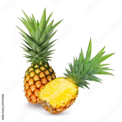 Half and whole pineapple fruits isolated on a white background.