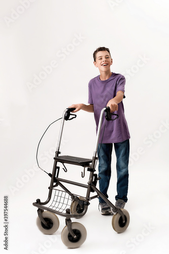 Konstfotografi Full length shot of happy teenaged disabled boy with cerebral palsy smiling at c