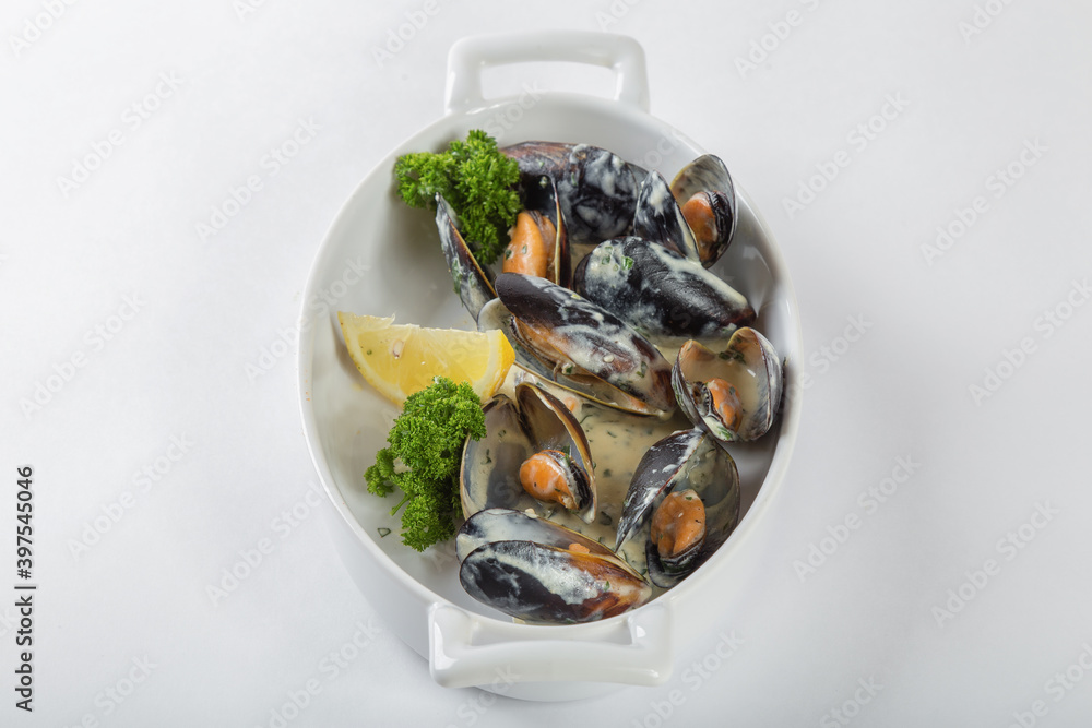 Double-leaf mussels in creamy mustard sauce, white background